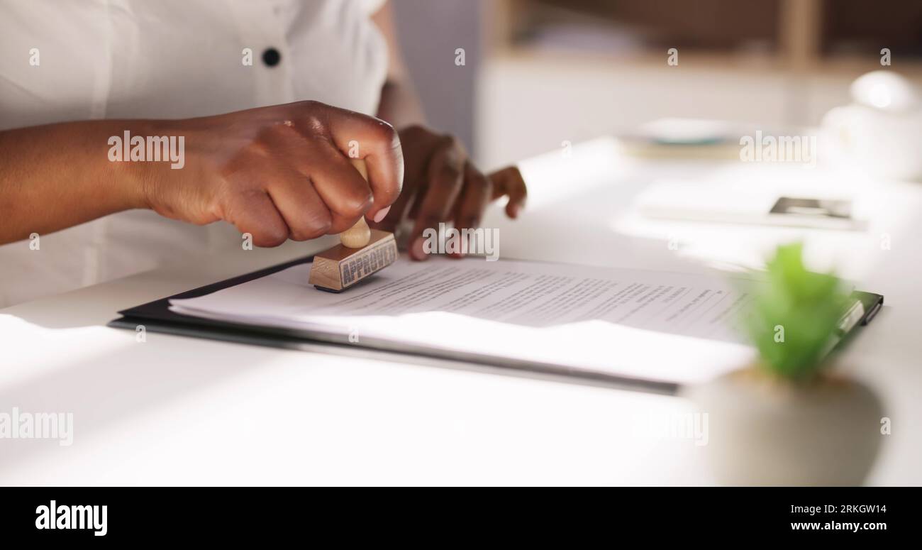 African American Black Woman Using Notary Stamp On Official Paper Stock Photo