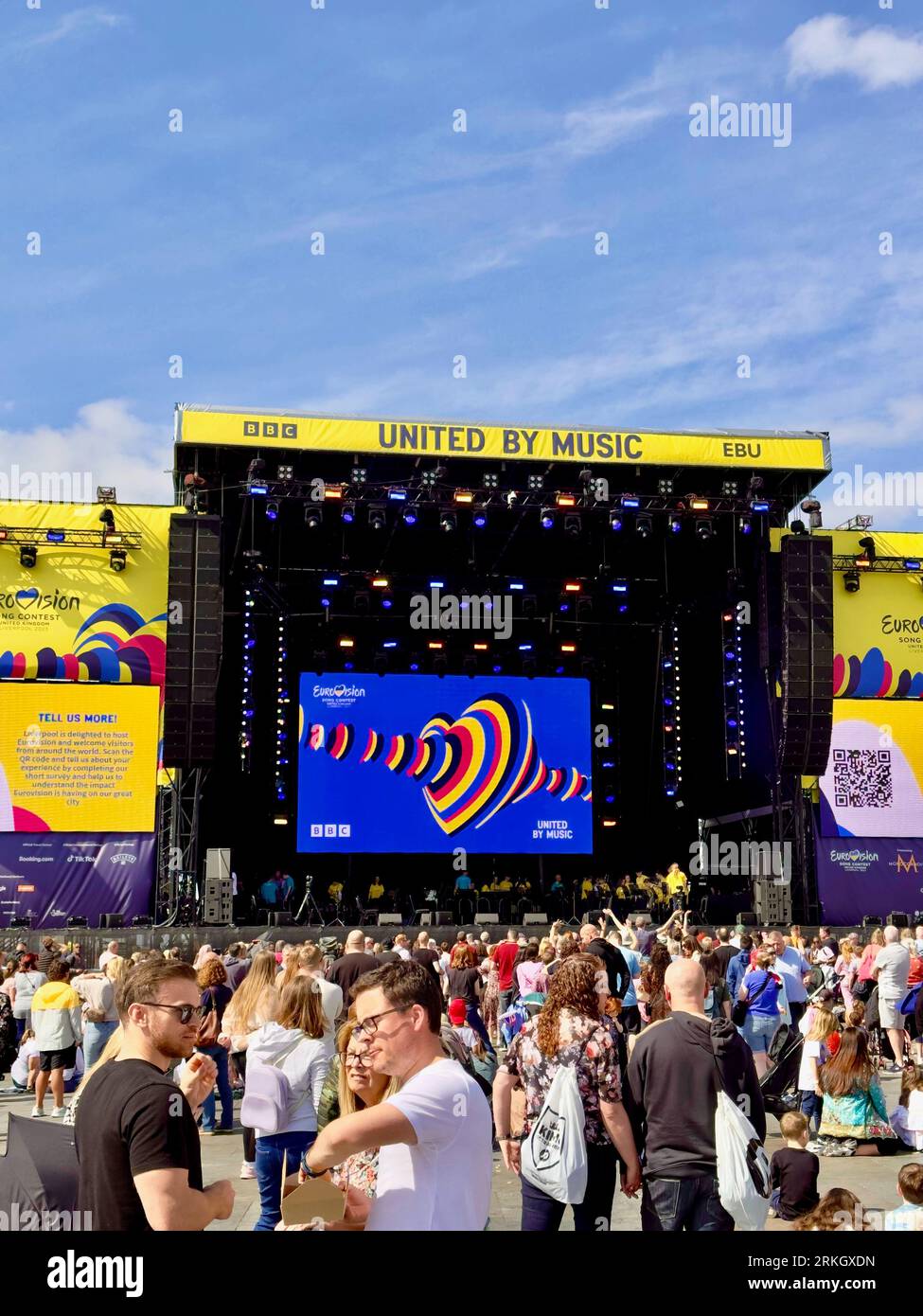 A group of performers captivate the audience on stage, with a crowd of