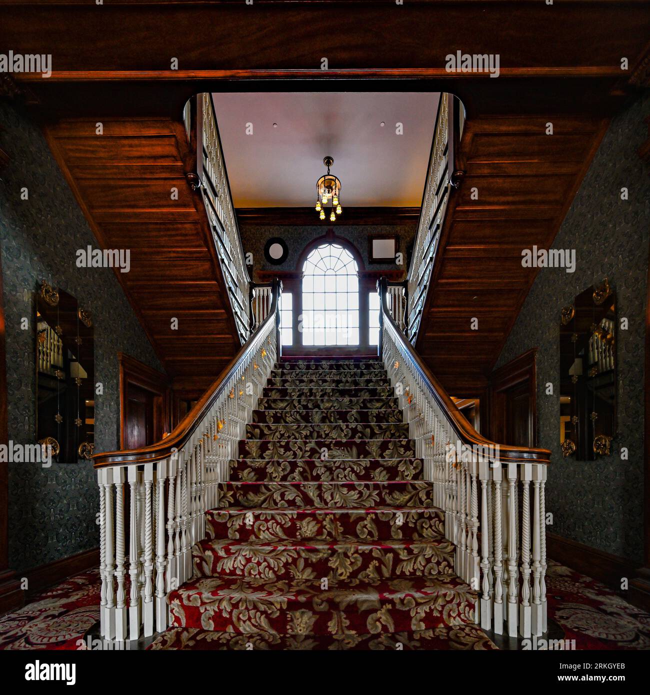 An interior wooden staircase leading up to the second floor, with the ...