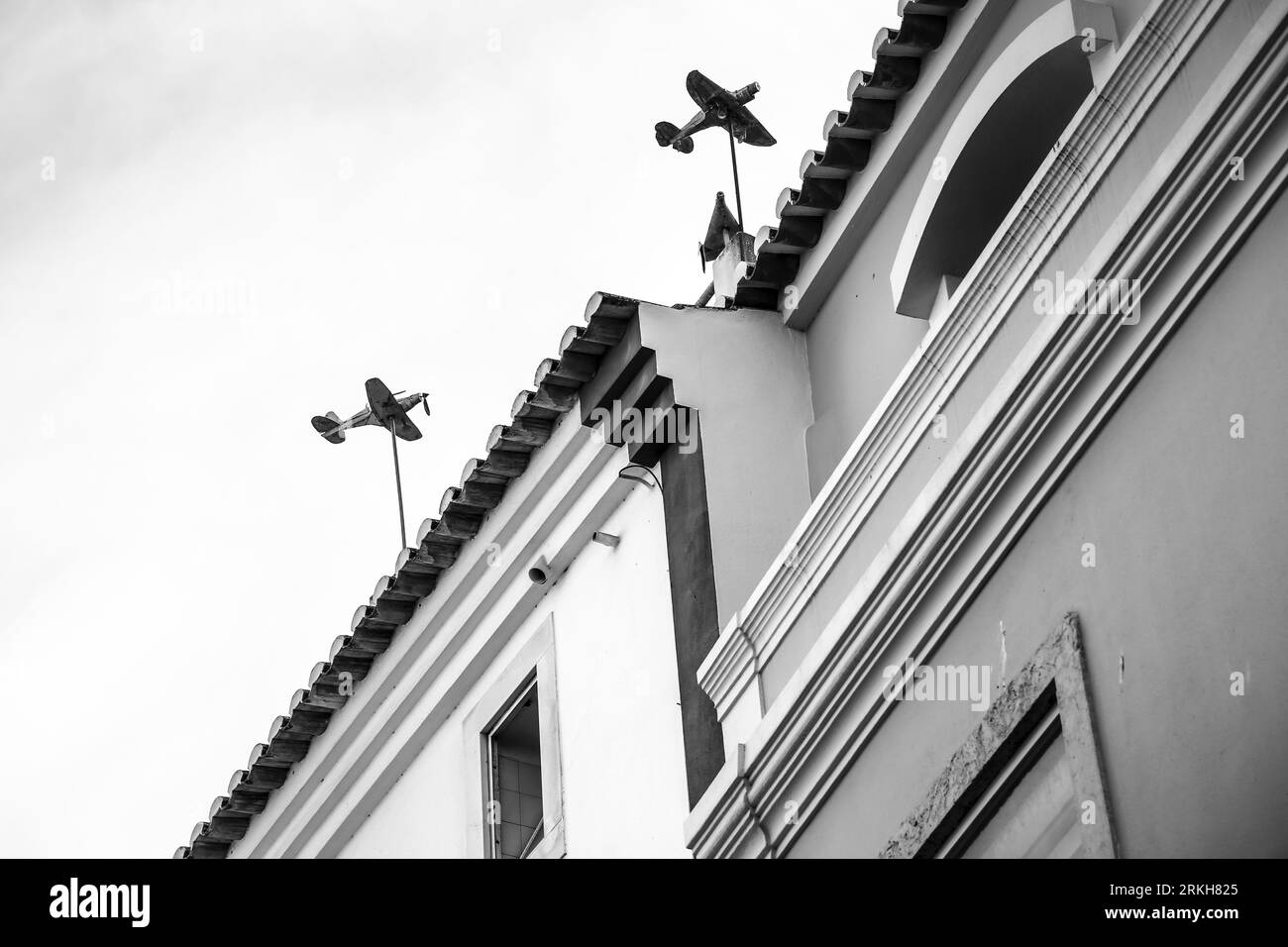 Airplane shaped weather vanes in a building in Lagos. Monochrome picture. Stock Photo