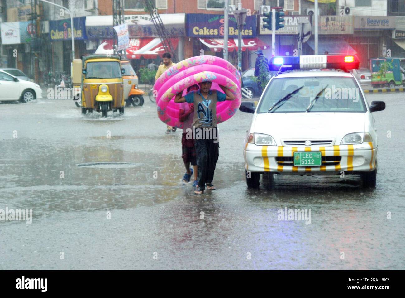 Pakistani children play in flooded water after heavy monsoon rain