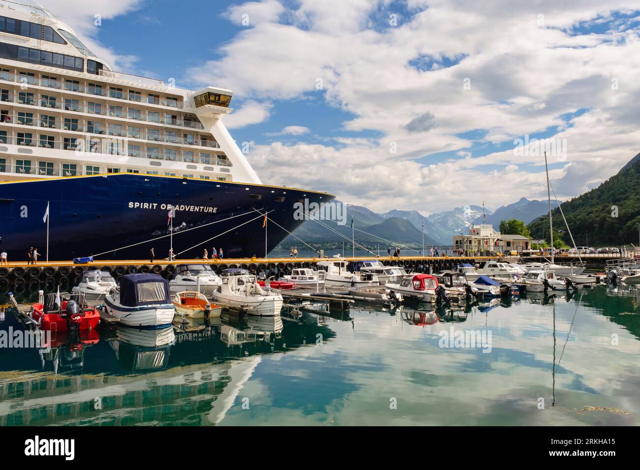 Saga cruise ship and small boats moored by jetty in Tindekaia harbour in Romsdalsfjorden fjord in summer. Andalsnes, Møre og Romsdal, Norway Stock Photo