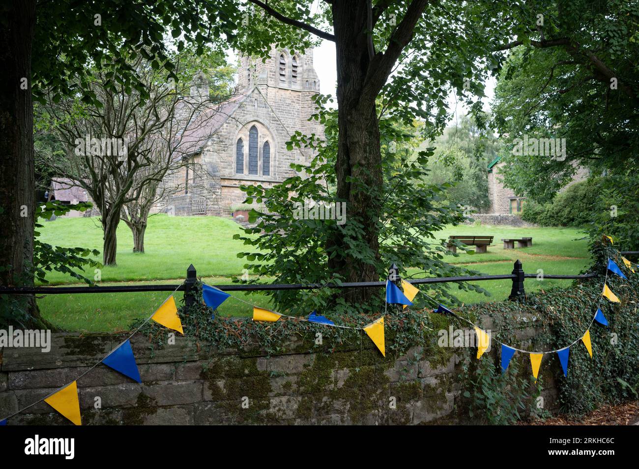 An exterior of the Anglican parish church  and summer bunting at Edale in the Peak District National Park, on 24th August 2023, in Sheffield, England. Stock Photo