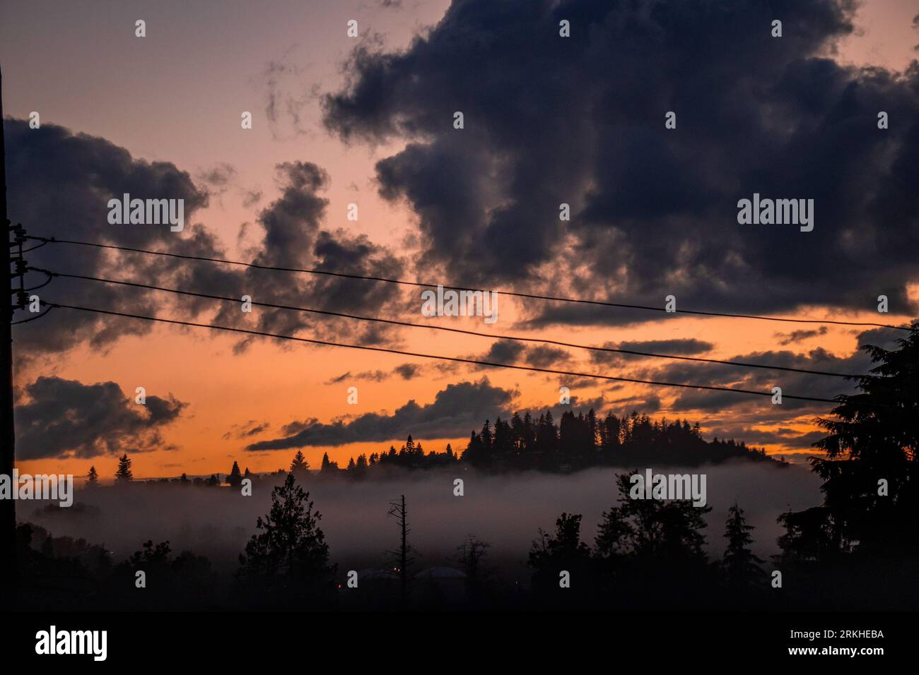 A dramatic dark sky with power lines running through the landscape ...