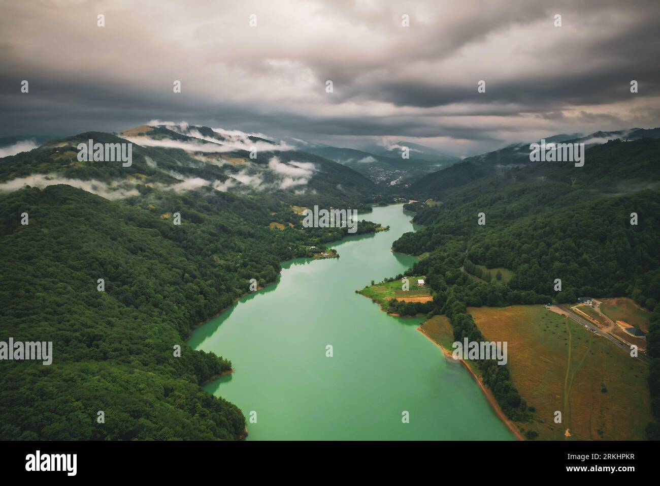 This scenic image depicts a tranquil river winding its way through a ...