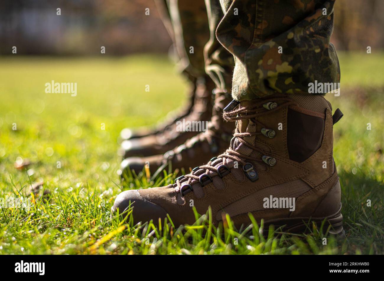 A closeup of combat boots of the German Army Bundeswehr in the grass Stock Photo