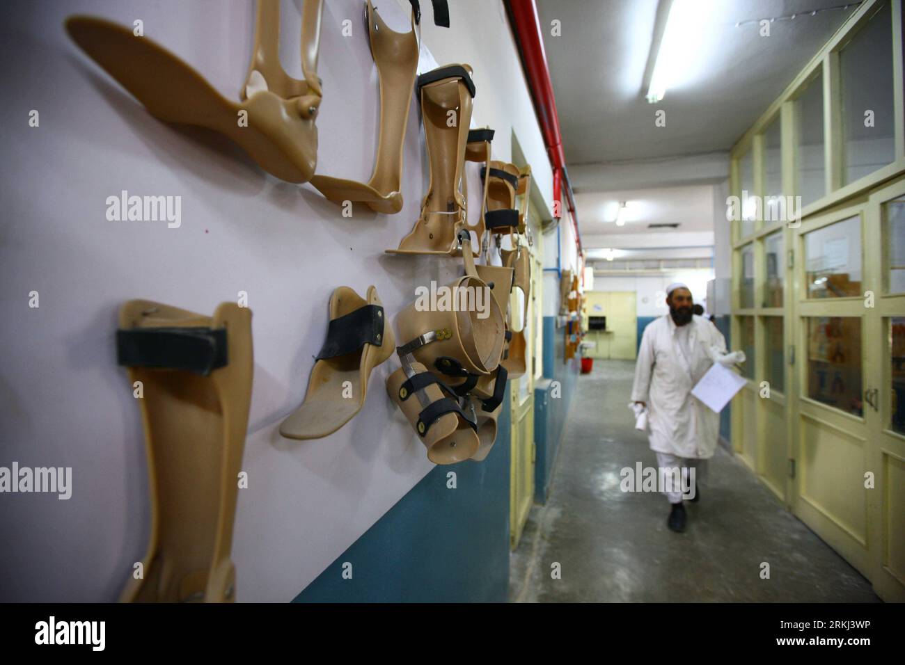 Bildnummer: 55977076  Datum: 14.09.2011  Copyright: imago/Xinhua (110915) -- KABUL, Sept. 15, 2011 (Xinhua) -- A man walks past the wall with artificial limbs hanging on at the International Committee of the Red Cross (ICRC) Orthopaedic Center Ali Abad Kabul-Afghanistan, in Kabul, Afghanistan, Sept. 14, 2011. There are almost one million disabled in Afghanistan and the rate of disabled among the whole population is quite high, due to the chaos caused by war for many years in Afghanistan. The ICRC Orthopaedic Center Ali Abad Kabul-Afghanistan, established in 1988, offers not only artificial lim Stock Photo