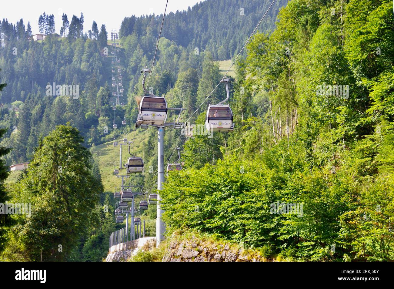 Söll, Austria, August 6, 2013. The Hoch Söll Cable car moving up through the trees. Stock Photo