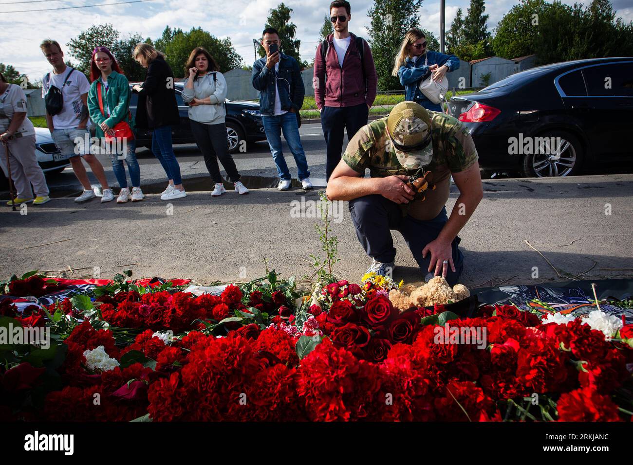 A member of the Wagner group lays flowers at a spontaneous memorial in ...