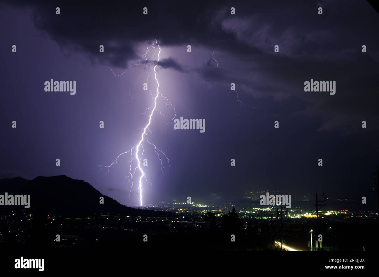 A night sky illuminated with a dazzling display of purple lightning ...