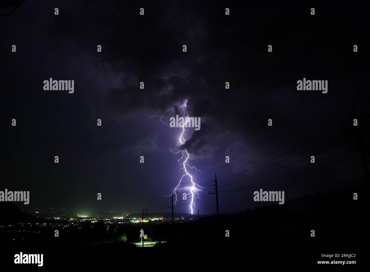 A night sky illuminated with a dazzling display of purple lightning ...