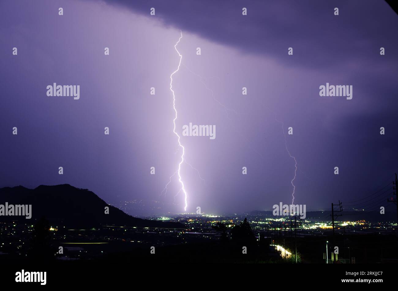 A night sky illuminated with a dazzling display of purple lightning ...