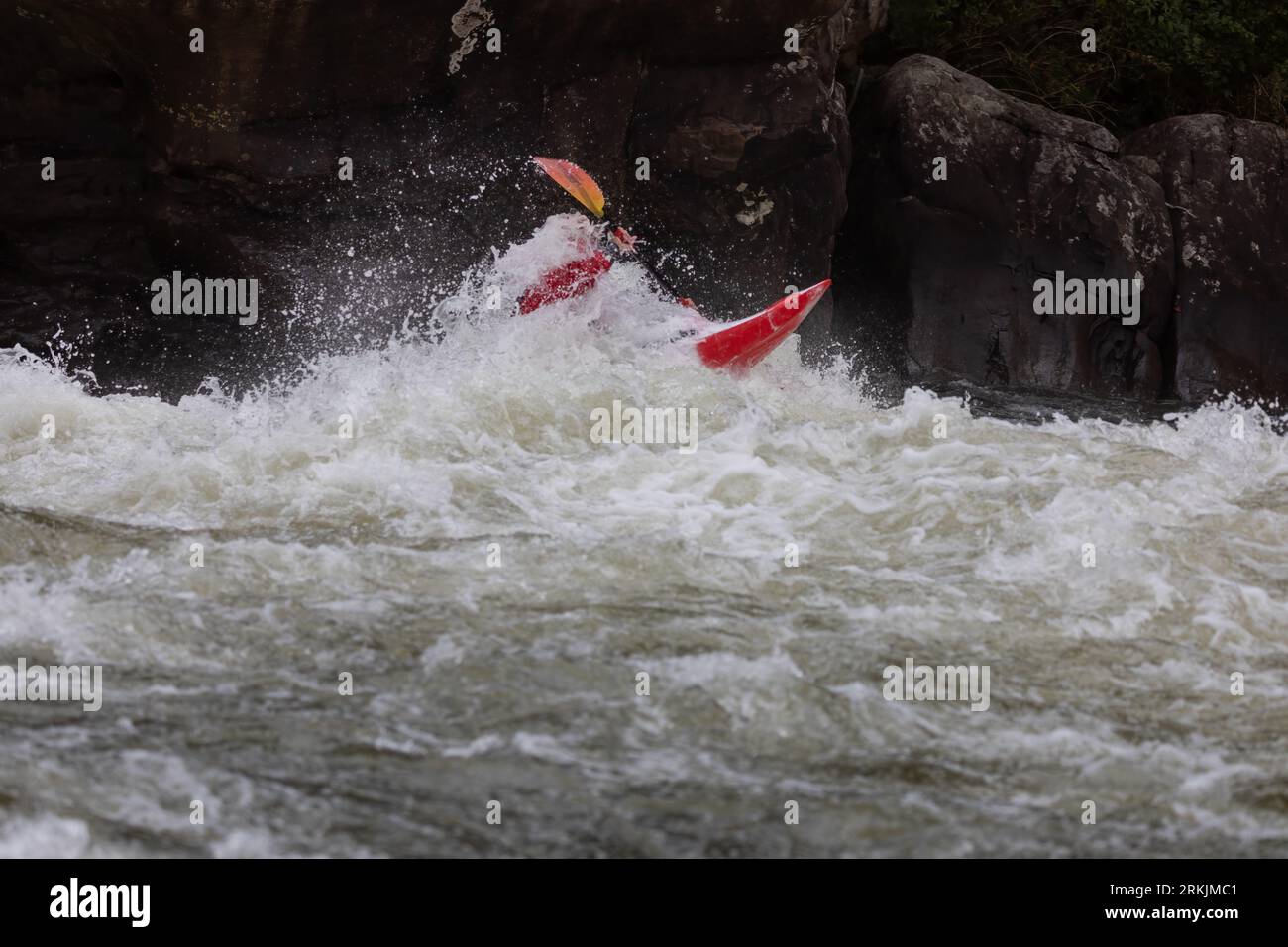 An adventurous kayaker navigating the challenging rapids of the Gauley River in West Virginia Stock Photo