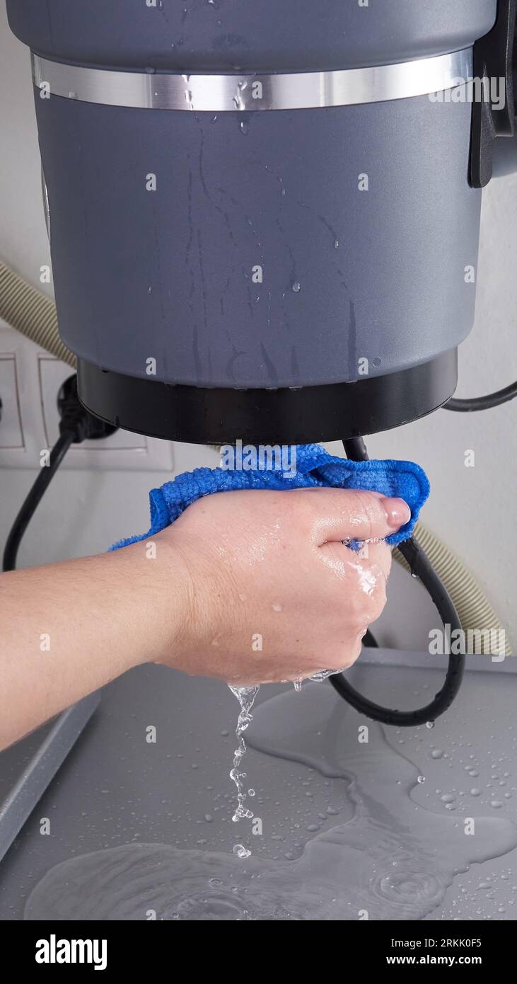 Waste disposal leak under a sink, broken garbage chopper Stock Photo Alamy