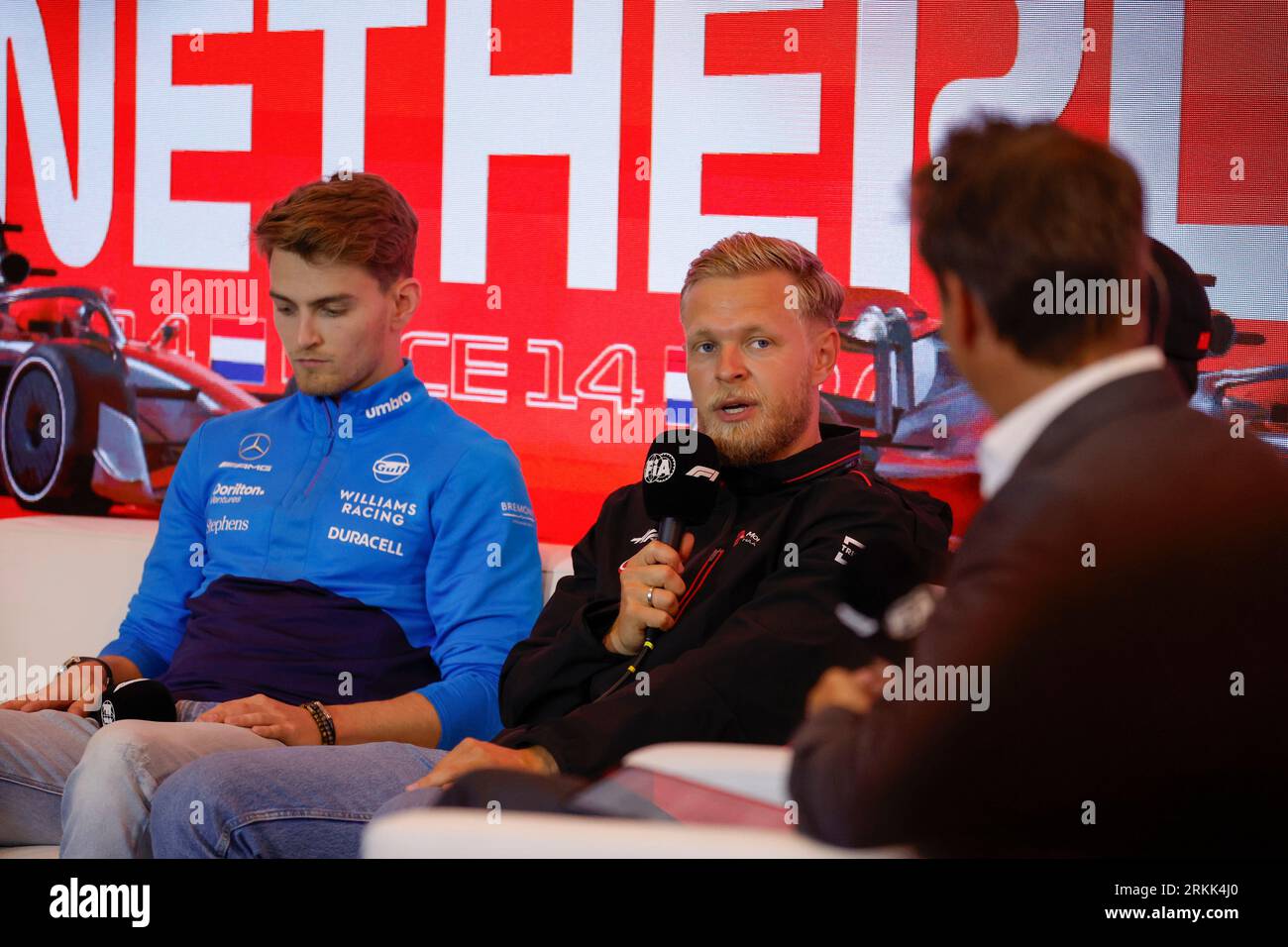 ZANDVOORT, NETHERLANDS - AUGUST 24: Kevin Magnussen of MoneyGram Haas F1 Team talk and Logan Sargeant of Williams Racing looks on at the FIA drivers p Stock Photo