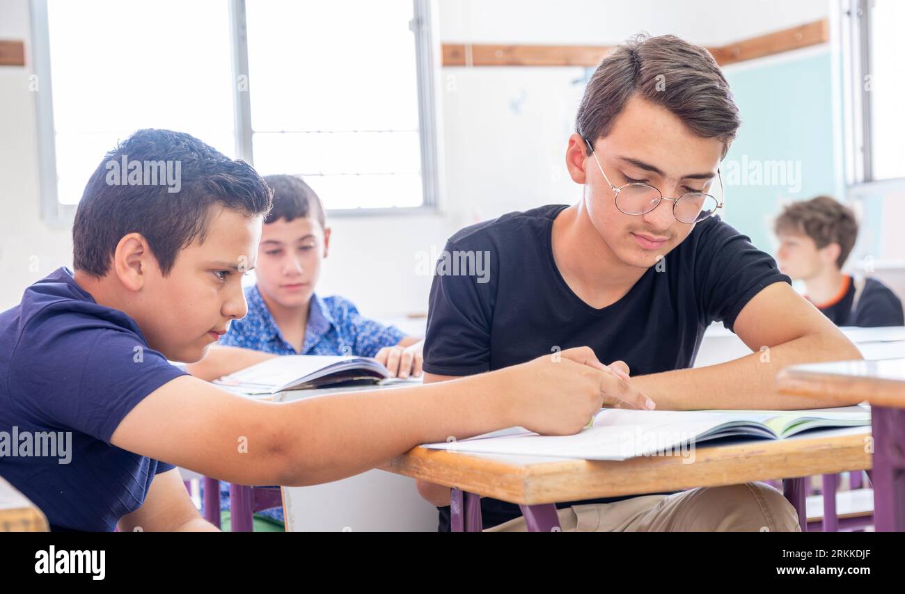 group of students in school having discussion about some studying fields Stock Photo