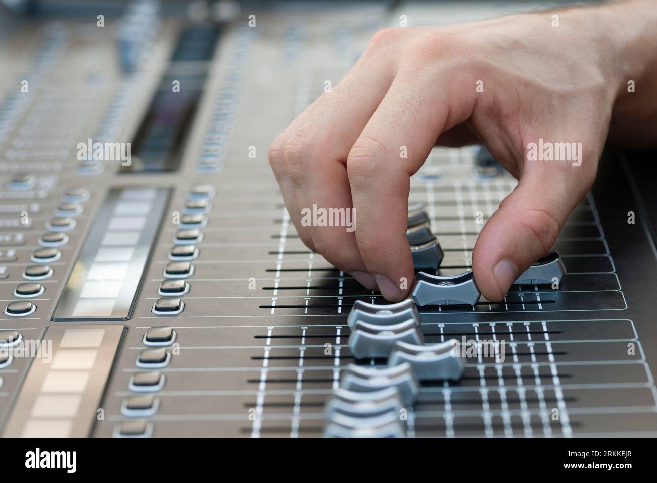 Sound Engineer Operating Professional Sound Mixer at Live Concert, Hand. Stock Photo