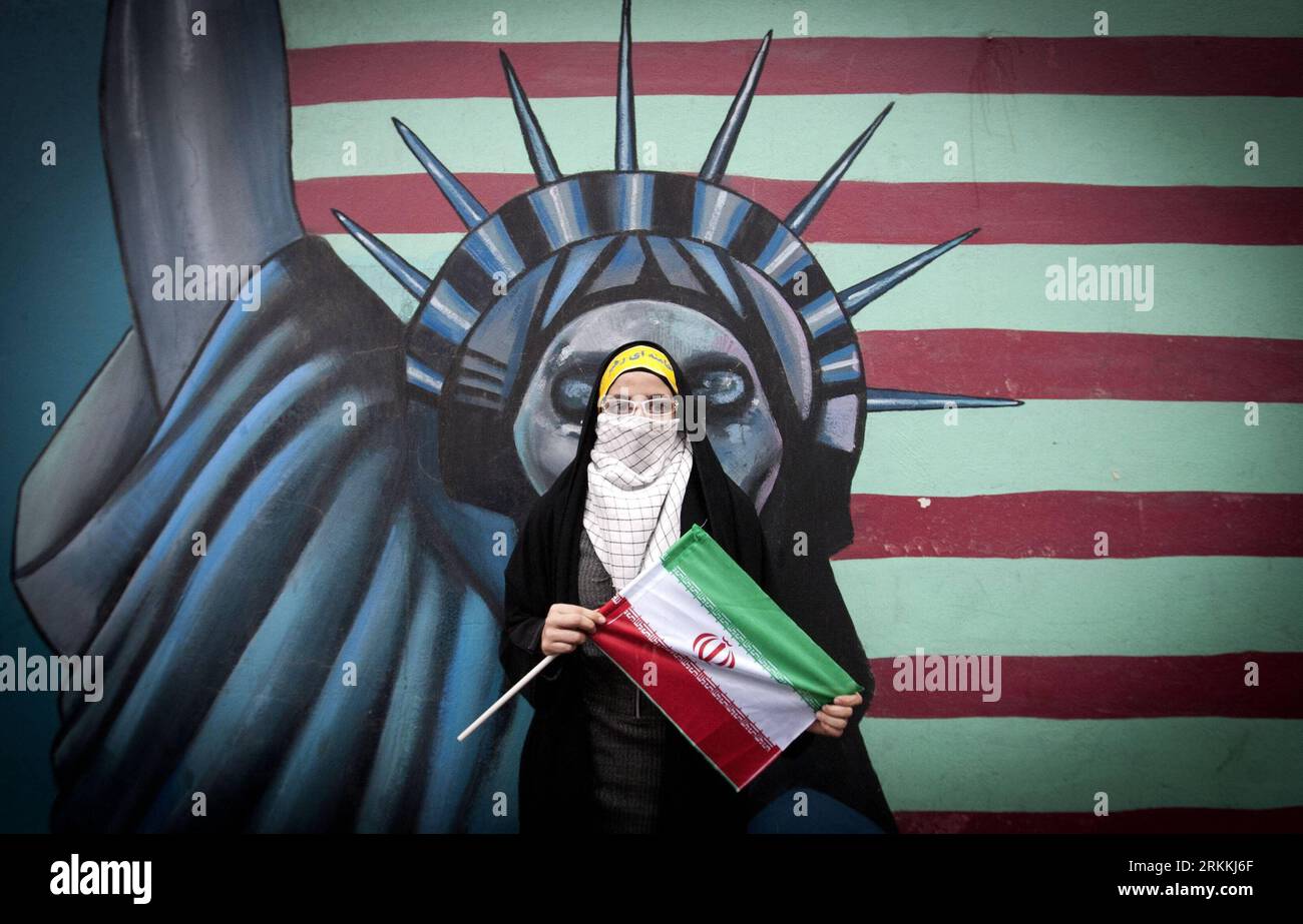 111104 -- TEHRAN, Nov. 4, 2011 Xinhua -- A student holds an Iran flag during a rally marking the 32nd anniversary of the seizure of the U.S. Embassy in downtown Tehran, Iran, Nov. 4, 2011. Iranians on Friday marked the anniversary of the seizure of the U.S. embassy in Tehran by Iranian students 32 years ago. The United States cut diplomatic relations with Iran on April 7, 1980, after a group of Iranian students seized the U.S. embassy in Tehran and captured some 60 U.S. diplomats in 1979. In the hostage crisis, 52 of the U.S. diplomats were held in captivity for 444 days.Xinhua/Ahmad Halabisaz Stock Photo