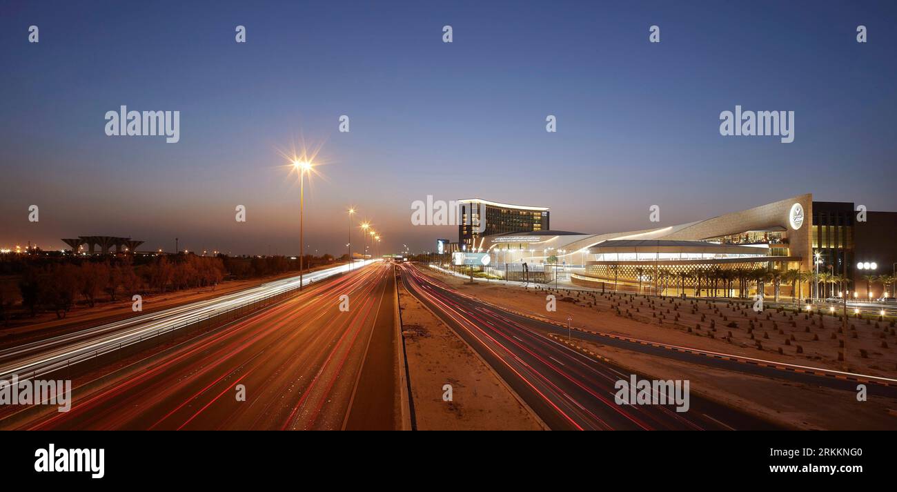 Dusk elevation with street and sunset sky. 360 Mall, Kuweit City, Kuwait. Architect: CRTKL, 2021. Stock Photo