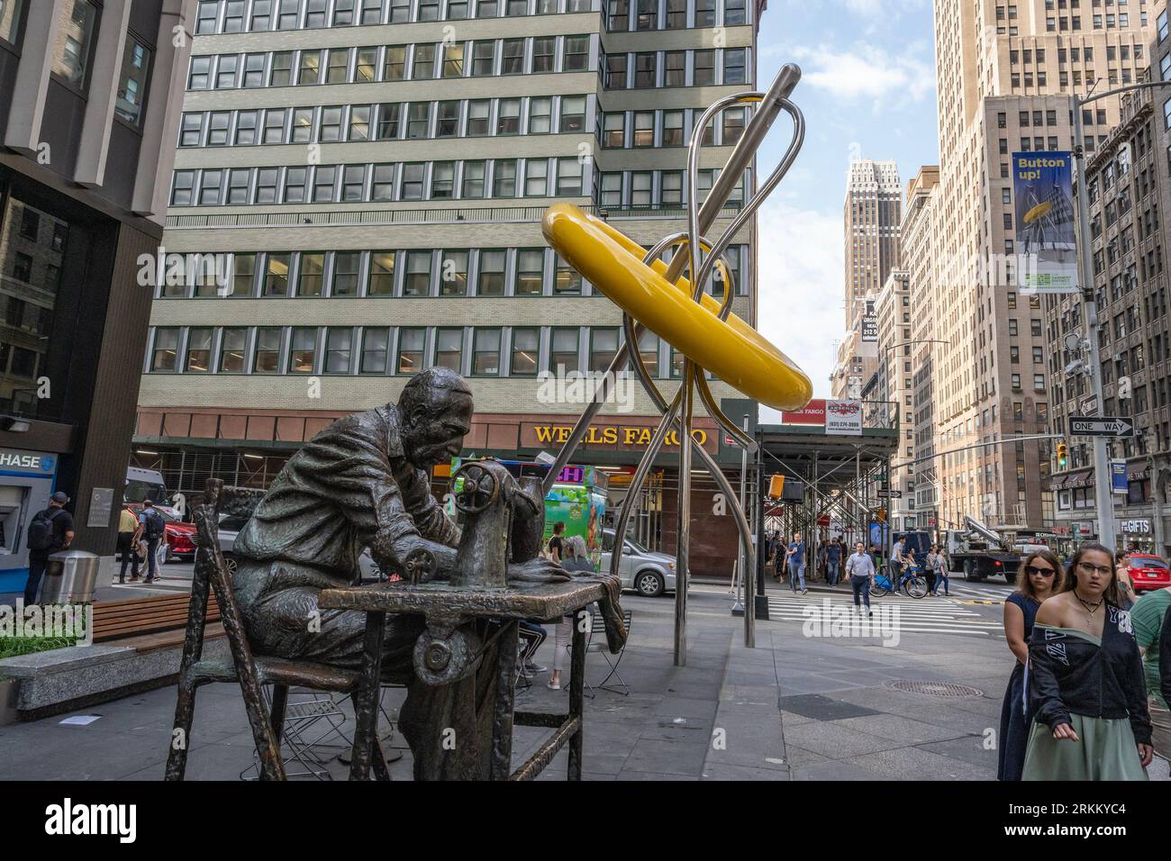 New York, USA - July 20th, 2023: The big button and the Garment Worker sculptures in the garment district neighborhood, Manhattan, New York. Stock Photo