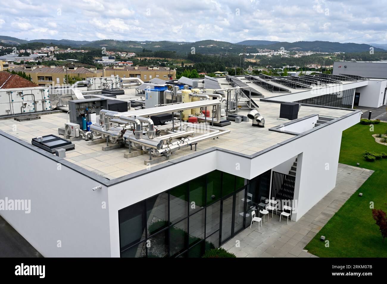 The complexity of pipes and cylinders atop a building with solar thermal panels and heat pumps, roof of CentroDial, dialysis center, São João da Madei Stock Photo