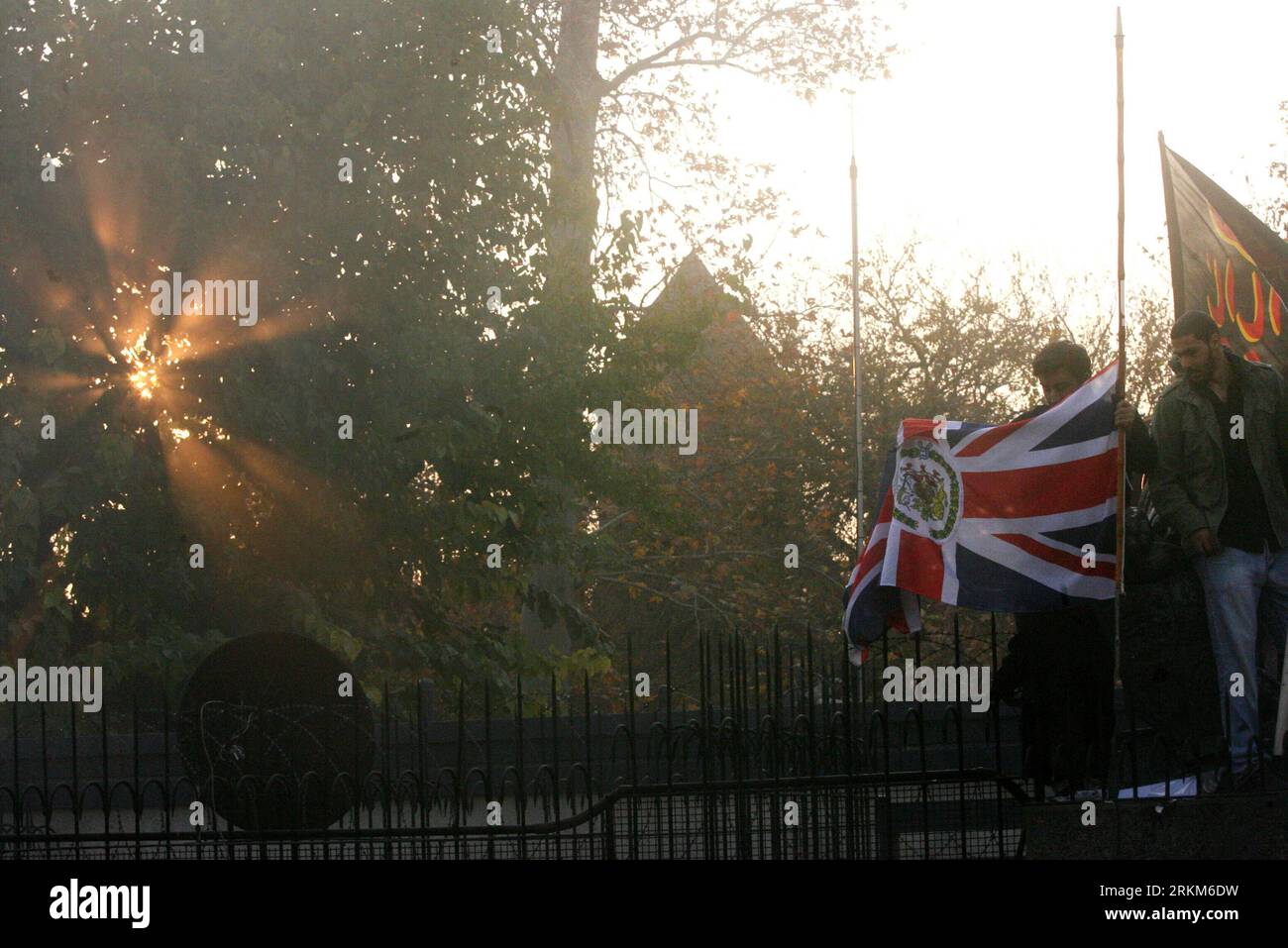 Bildnummer: 56531579  Datum: 29.11.2011  Copyright: imago/Xinhua (111130) -- TEHRAN, Nov. 30, 2011 (Xinhua) -- An Iranian student drags down a British flag in the British embassy in Tehran, Iran, Nov. 29, 2011. Angry students from Iranian universities Tuesday stormed the British embassy compound in Tehran and dragged down the British flag. (Xinhua/Ahmad Halabisaz) (zjl) IRAN-TEHRAN-PROTEST-BRITISH EMBASSY PUBLICATIONxNOTxINxCHN Gesellschaft Politik Britische Botschaft Protest Randale Unruhen stürmen Erstürmung Nationalflagge Flagge premiumd xbs x0x 2011 quer      56531579 Date 29 11 2011 Copyr Stock Photo