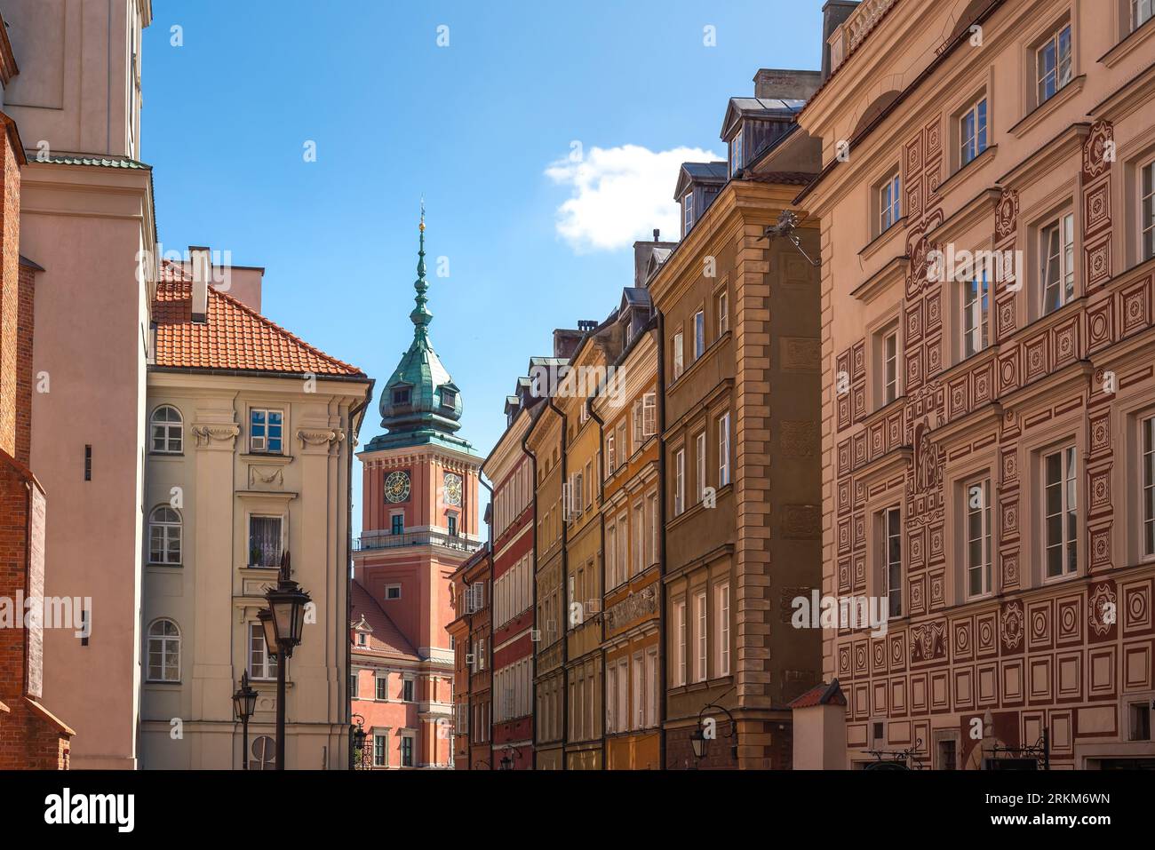 Street in old town with Royal Castle Clock Tower - Warsaw, Poland Stock Photo