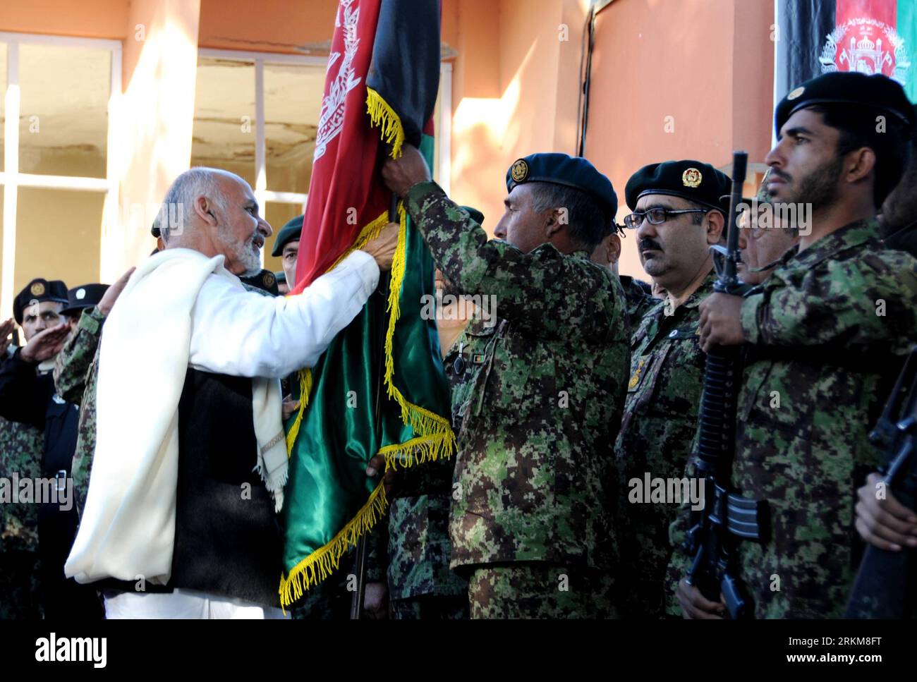 Bildnummer: 56541728  Datum: 02.12.2011  Copyright: imago/Xinhua (111201) -- AFGHANISTAN, Dec. 1, 2011 (Xinhua) -- Afghan Transition Coordination Commission Asharaf Ghani Ahmadzai (L) hands over the national flag of Afghanistan to Afghan National Army (ANA) soldiers during the security transition ceremony in Parwan province north of Kabul, Afghanistan, Dec. 1, 2011. The government of Afghanistan began the second phase of taking over security responsibilities from NATO-led International Security Assistance Force (ISAF) on Thursday. (Xinhua/Ahmad Massoud) (jl) AFGHANISTAN-NATO-SECURITY TRANSITIO Stock Photo