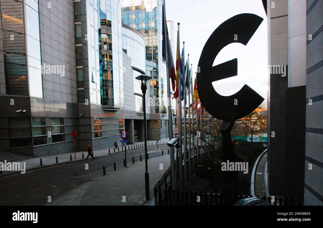 Bildnummer: 56652620  Datum: 06.12.2011  Copyright: imago/Xinhua (111206) -- BRUSSELS, Dec. 6, 2011 (Xinhua) --Pedestrians pass a statue holding the symbol of euro, outside the European Parliament building in Brussels, capital of Belgium, Dec. 6, 2011. EU leaders will gather during this week s summit in Brussels, struggle to forge an accord on ways to tackle the region s debt crisis. (Xinhua/Zhou Lei)(zl) BELGIUM-EU-EURO PUBLICATIONxNOTxINxCHN Politik EU Gipfel Europa Krise Wirtschaftskrise Finanzkrise Euro Wirtschaft Objekte Impressionen Schuldenkrise x0x xub 2011 quer      56652620 Date 06 1 Stock Photo