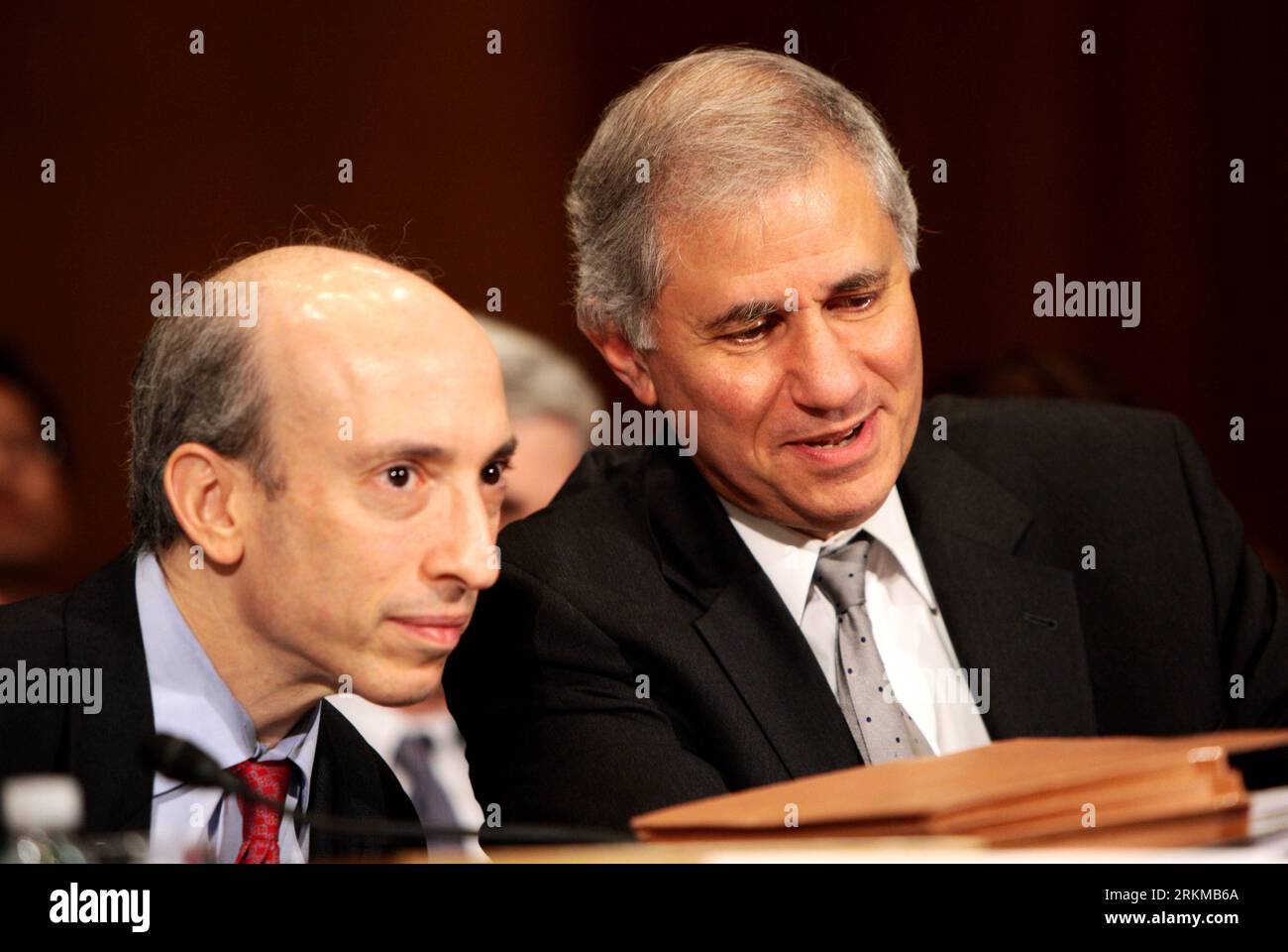 Bildnummer: 56657374  Datum: 06.12.2011  Copyright: imago/Xinhua (111206) -- WASHINGTON, Dec. 6, 2011 (Xinhua) -- Martin Gruenberg (R), acting chairman of the Federal Deposit Insurance Corp. (FDIC), talks with Gary Gensler, chairman of the U.S. Futures Commodities Trading Commission (CFTC) during a Senate Banking Committee hearing in Washington, D.C., the United States, Dec. 6, 2011. While the United States has made much progress in the implementation of the Dodd-Frank Act, there is still much work left to strengthen financial regulation after the world s largest economy was hit seriously by t Stock Photo