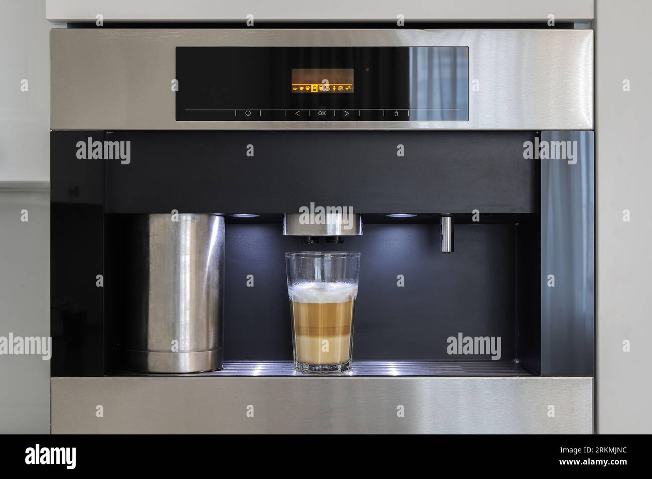 Builtin fully automatic coffee machine in kitchen furniture Stock