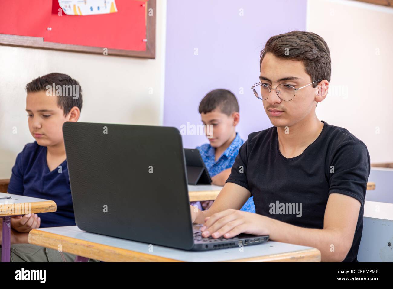 arabic teenager using laptop while studying in the school Stock Photo ...