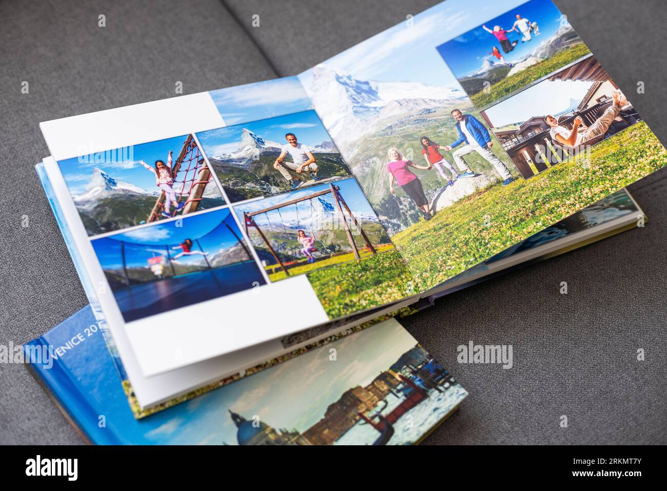 a Photobook of family at home on a background. Photobook is gift. professional photographer and designer. printing of photos and journals in photo Stock Photo