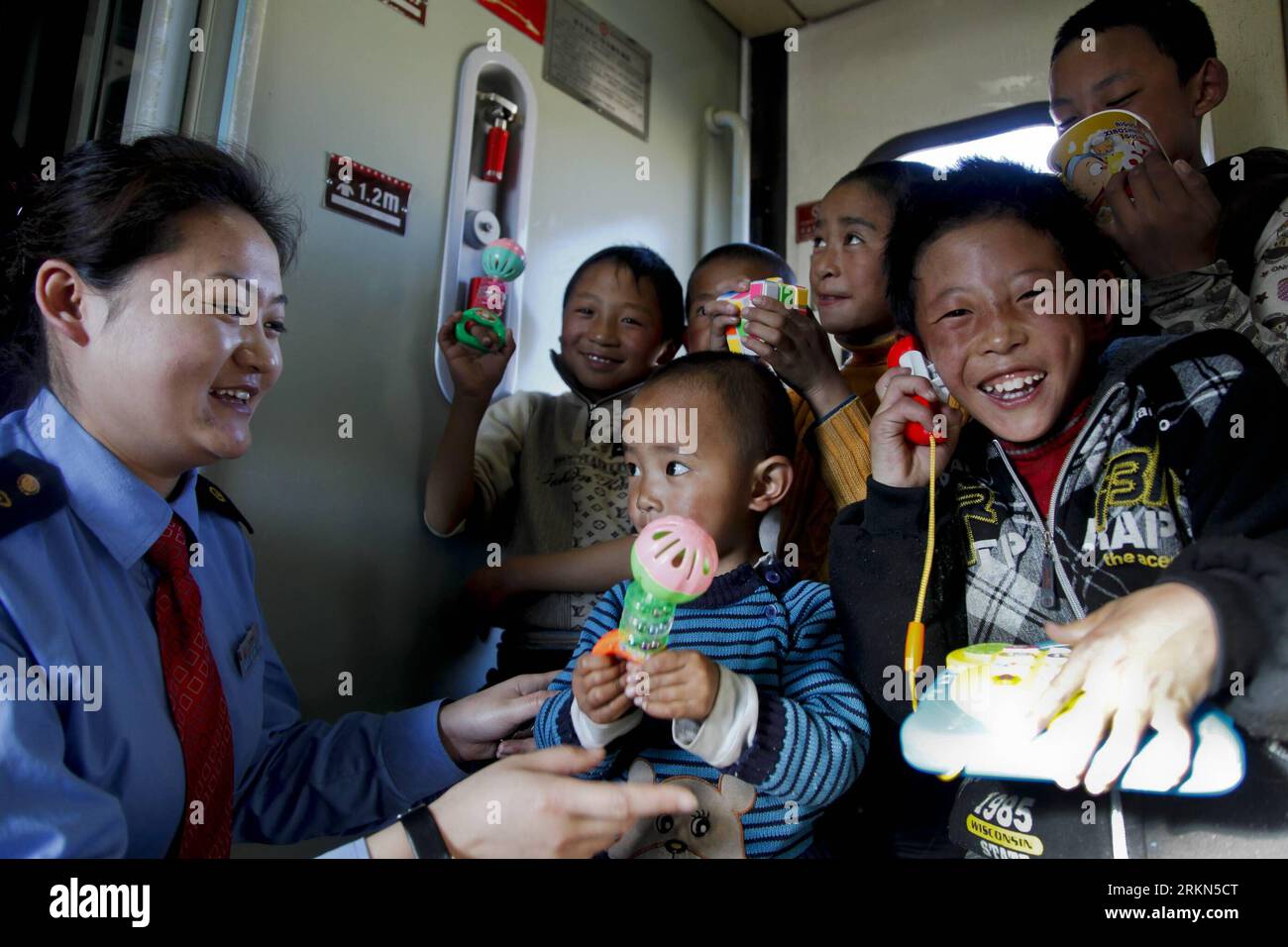 Bildnummer: 56986225  Datum: 30.01.2012  Copyright: imago/Xinhua (120130) -- XINING, Jan. 30, 2012 (Xinhua) -- A conductor gives children toys at a train that runs on the Qinghai-Tibet railway in southwest China s Qinghai Province, Jan. 29, 2012. The Qinghai-Tibet Railway Company carried out 20 new services as the number of passengers rises after the Spring Festival holiday. The new services includes providing poker cards, chess, toys and so on for passengers. (Xinhua/Wu Gang) (zhs) CHINA-XINING-RAILWAY-SERVICE (CN) PUBLICATIONxNOTxINxCHN Gesellschaft Bahn Verkehr Kind Betreuung Zugbegleiter x Stock Photo