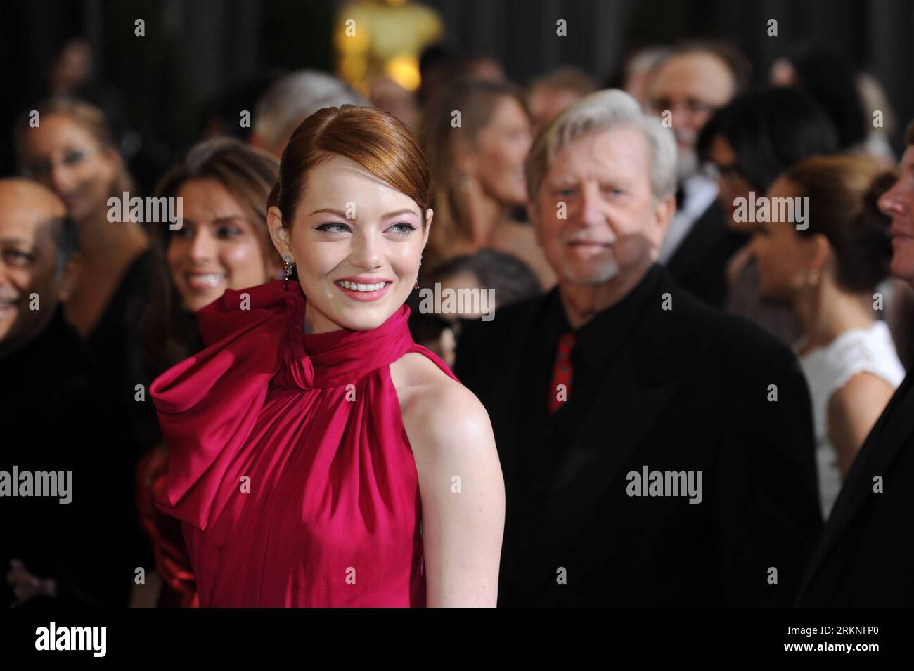 Feb. 26, 2012 - Hollywood, California, U.S. - EMMA STONE wears a red  Giambattista Valli gown and Louis Vuitton jewels as she arrives on the  Oscar red carpet at the 84th Academy