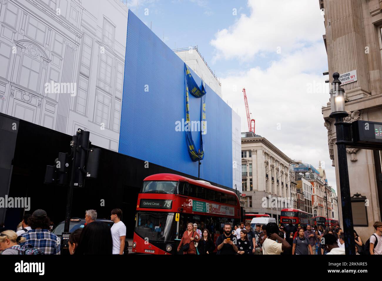 IKEA is set to open a store on Oxford Street in early 2024, the building is currently covered in scaffolding designed to look like a giant IKEA blue b Stock Photo