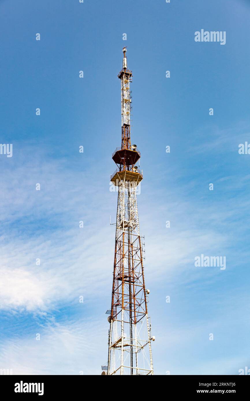 A telecommunications tower typical of Eastern Europe. Metal structure against the blue sky. Stock Photo