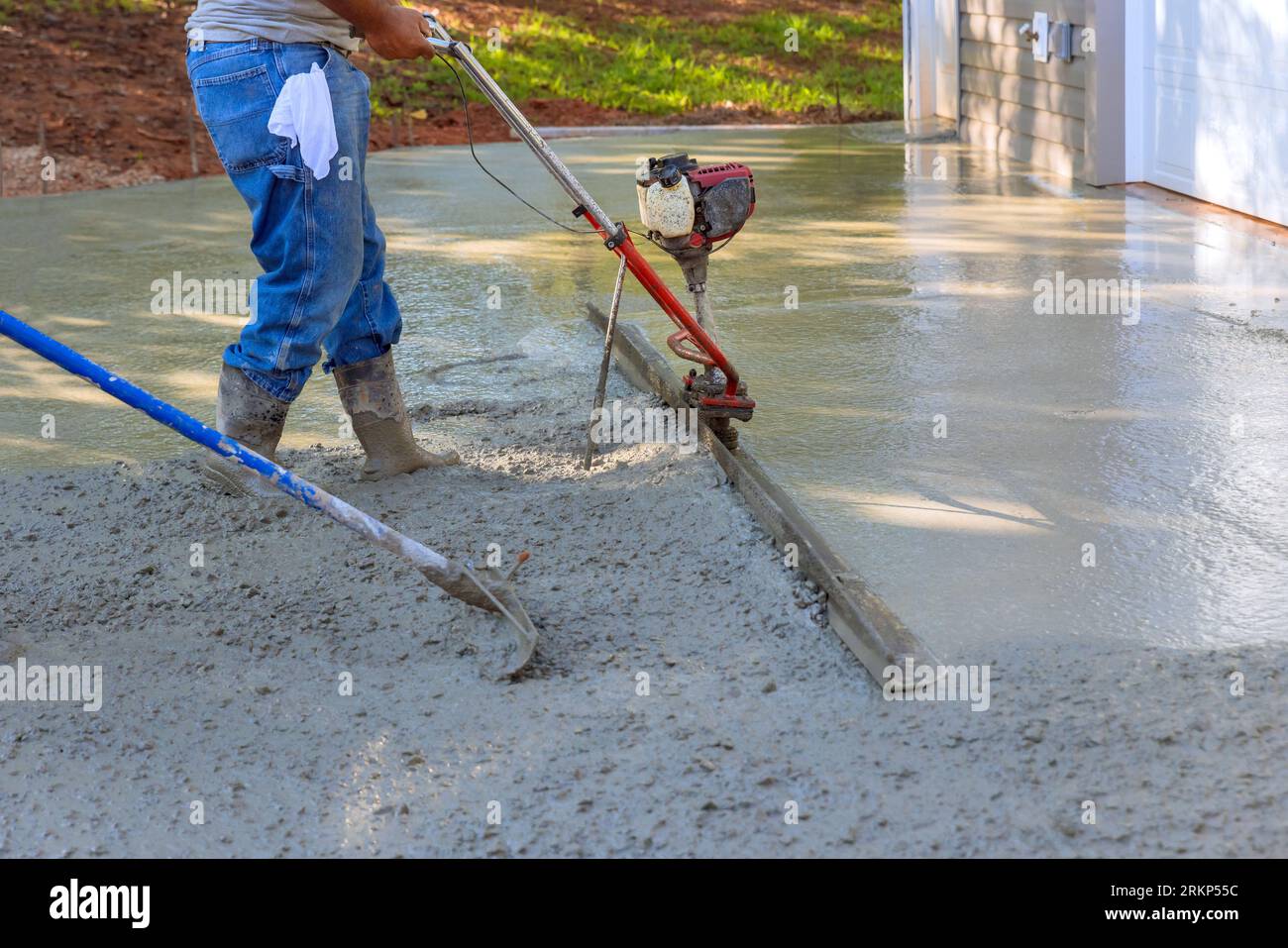 Utilizing tamping machine to align compacted concrete on new driveways