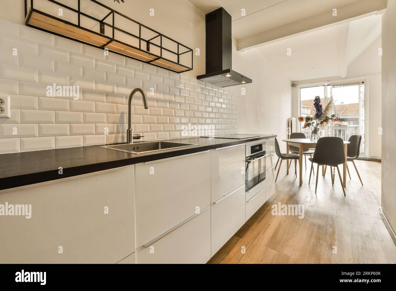 Kitchen with white stone countertops, solid wood cabinets, and vintage tile  on the walls Stock Photo - Alamy