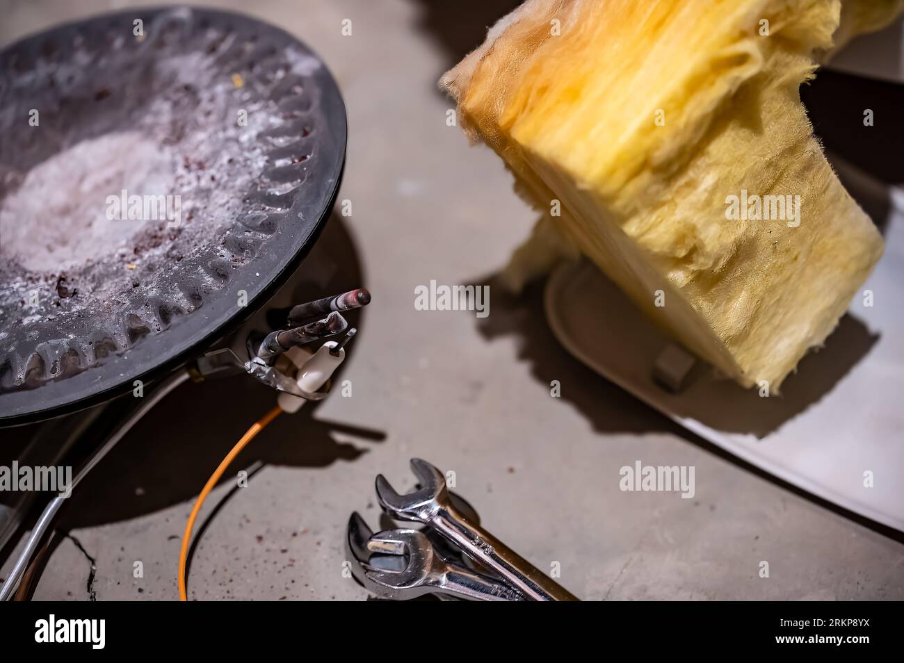 Hot water heater burner pan and element being replaced Stock Photo Alamy