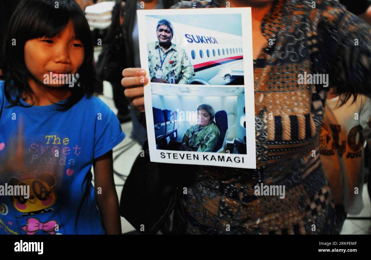 Bildnummer: 57976071  Datum: 10.05.2012  Copyright: imago/Xinhua (120510) -- JAKARTA, May 10, 2012 (Xinhua) -- Tasya Kamagi cries beside a printout with pictures of her father Steven Kamagi at Halim Perdana Kusuma airport, in Jakarta, Indonesia, May 10, 2012. Rescuers have arrived at the scene of the Sukhoi super jet 100 crash and found some dead bodies, but have not found any survivors yet, a government official said here on Thursday. Steven Kamagi, who was on the flight, had sent his wife the photographs via his mobile phone just before the plane took off. (Xinhua/Agung Kuncahya B.) INDONESI Stock Photo