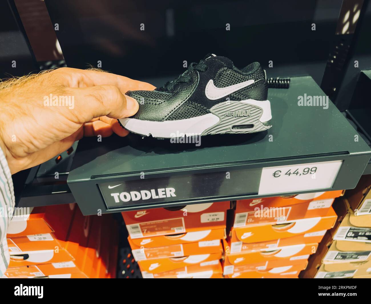 Roppenheim, France - July 11, 2023: POV male hand holding new toddler Nike  Air Max sport shoes with price of 44,99 euros in outlet store Stock Photo -  Alamy