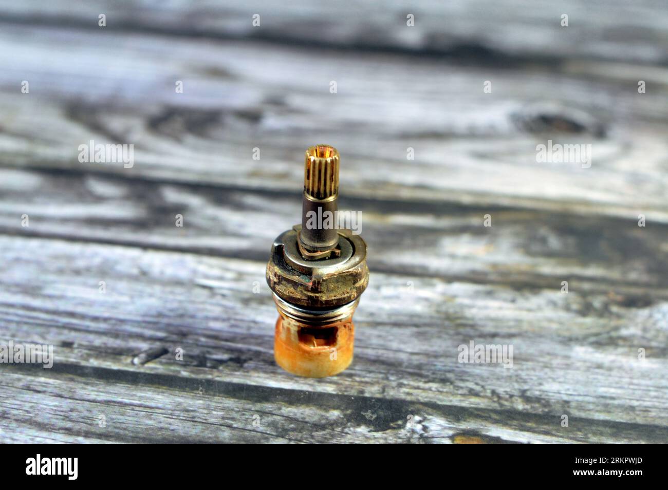 A used shower faucet tap body cartridge parts of plastic and copper