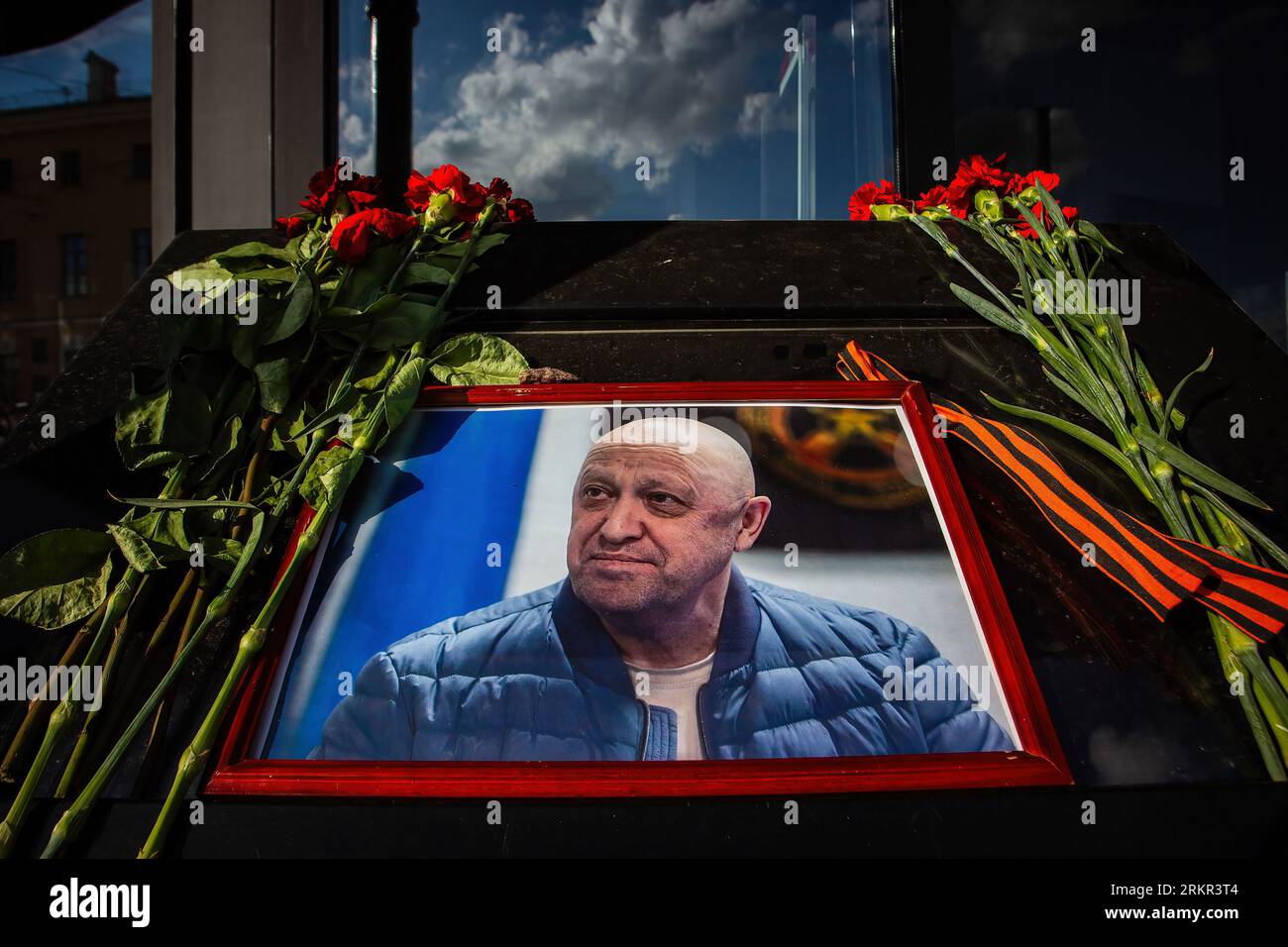 A portrait of Yevgeny Prigozhin, head of the private military company Wagner, and flowers laid in his memory at a cafe on Universitetskaya Embankment in St. Petersburg, which belongs to him. On Wednesday, August 23, the Federal Air Transport Agency confirmed in a statement the death of 10 people who were on board a business jet belonging to businessman and founder of Wagner PMC Yevgeny Prigozhin, which crashed in the Tver region, Russia. The Federal Air Transport Agency also confirmed that Yevgeny Prigozhin was on the list of 10 people on board, among whom 3 were crew members. Also on this lis Stock Photo