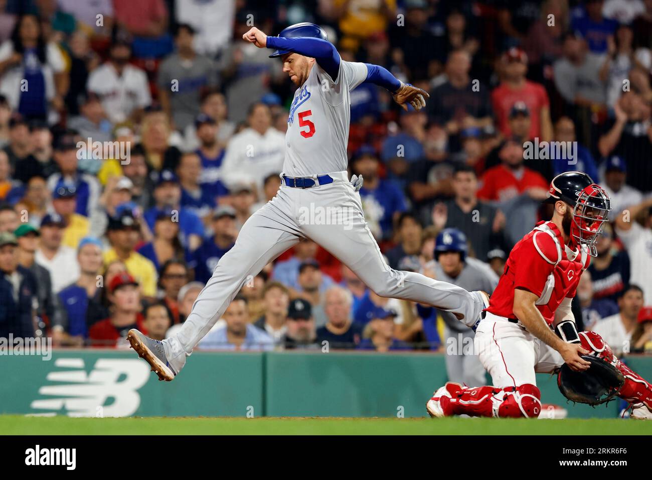 Los Angeles Dodgers' Freddie Freeman (5) scores behind Boston Red Sox  catcher Connor Wong on a sacrifice fly by David Peralta during the ninth  inning of a baseball game, Friday, Aug. 25,