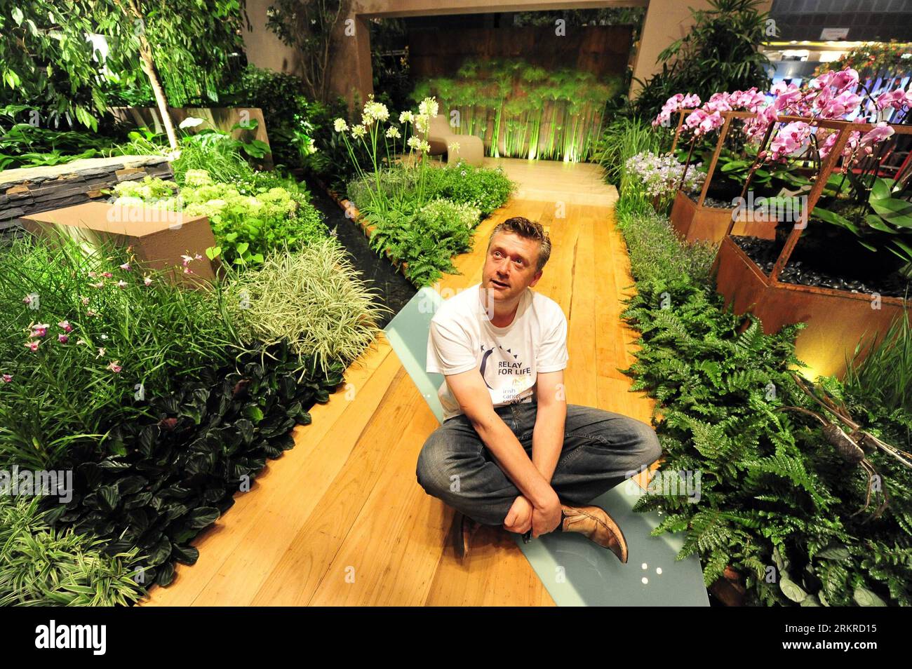 Bildnummer: 58200951  Datum: 06.07.2012  Copyright: imago/Xinhua (120706) -- SINGAPORE, July 6, 2012 (Xinhua) -- Ireland s designer Paul Martin poses for photos in his gold award-winning garden for Landscape Gardens category, The Path of Life , during a media preview of the Singapore Garden Festival in Singapore, July 6, 2012. The 4th Singapore Garden Festival will open to the public at Suntec Singapore International Convention & Exhibition Centre on Saturday. (Xinhua/Then Chih Wey) SINGAPORE-GARDEN FESTIVAL-PREVIEW PUBLICATIONxNOTxINxCHN Gesellschaft Gartenausstellung Ausstellung Garten Garte Stock Photo