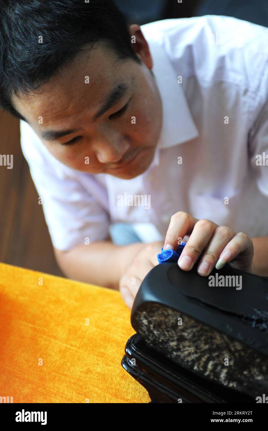 Bildnummer: 58328556  Datum: 07.08.2012  Copyright: imago/Xinhua (120809) -- SHEXIAN, Aug. 9, 2012 (Xinhua) -- Wen Xin cleans an inkstone carving in Shexian County of east China s Anhui Province, Aug. 7, 2012. Wen Xin, a 32-year-old man, is a master of inkstone carving in Shexian of Anhui Province. He started to learn the craftsmanship during his teenage years under the influence of his family. After years of study as research, Wen Xin developed a series of skills and patterns in carving the inkstone. The themes of his inkstones, various from landscapes, portrait, flowers to creatures. I alway Stock Photo