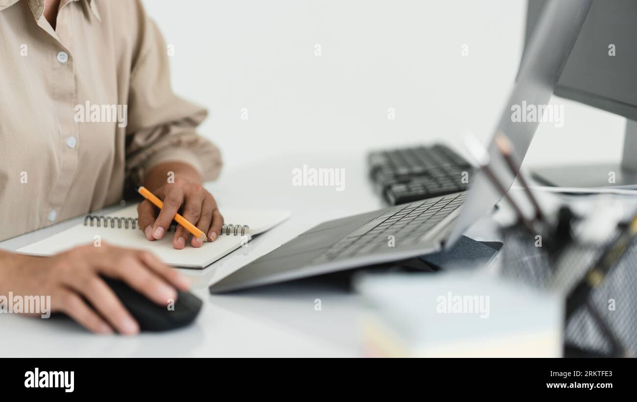 Developer programmer use mouse and checking code on laptop while programming to developing website. Stock Photo