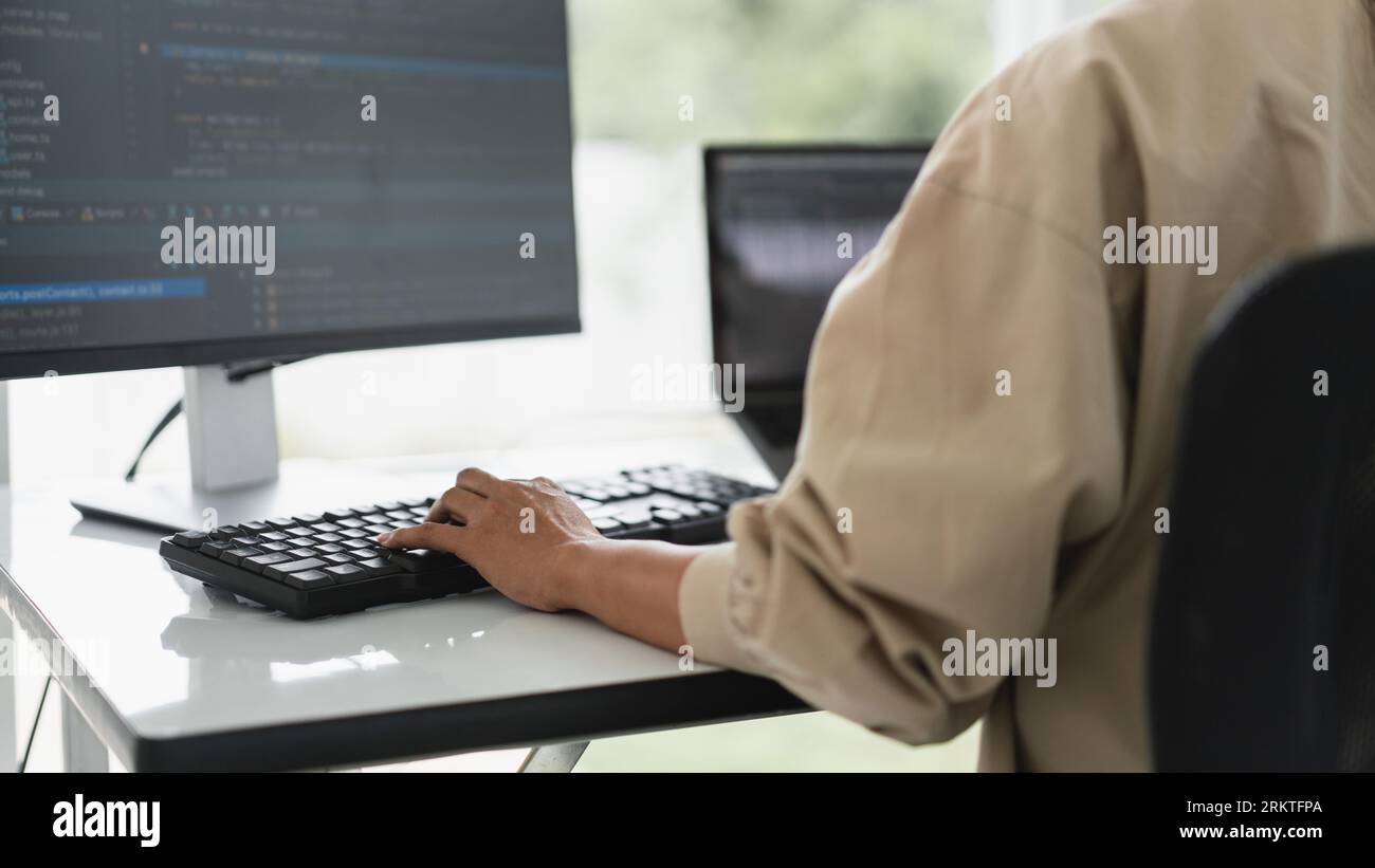 Developer programmer programming code to developing website and application in software office. Stock Photo