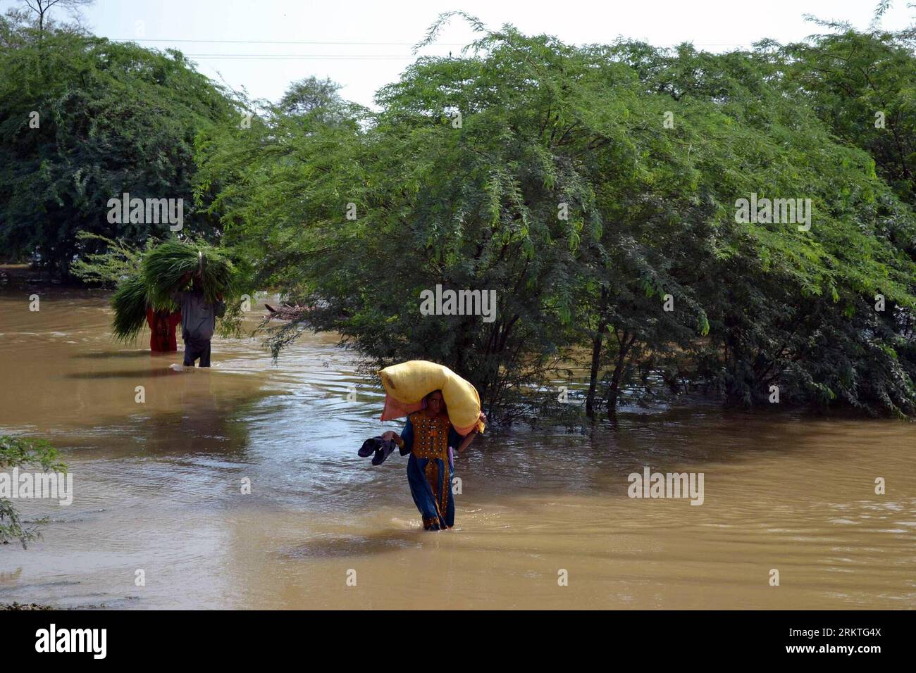 Bildnummer: 58471889  Datum: 14.09.2012  Copyright: imago/Xinhua (120914) -- DERA MURAD JAMALI, Sept. 14, 2012 (Xinhua) -- Pakistani carrying their belongings wade through the flooded area in Dera Murad Jamali, southwest Pakistan, Sept. 14, 2012. At least 136 were killed and 182 others were injured in flood triggered by heavy rains across Pakistan from Aug. 22 to Sept. 12, Pakistan National Disaster Management Authority said on Wednesday. (Xinhua/Iqbal Hussain) PAKISTAN-DERA MURAD JAMALI-FLOOD PUBLICATIONxNOTxINxCHN Gesellschaft Flut Überschwemmungen Wetter premiumd x0x xmb 2012 quer      5847 Stock Photo